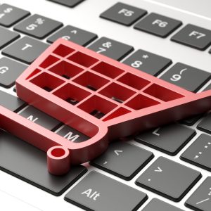 E shop, e commerce concept. Shopping cart trolley icon on a computer laptop. 3d illustration